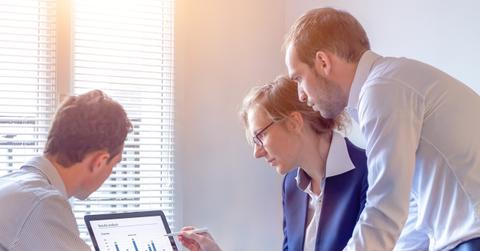 People looking at data on a laptop