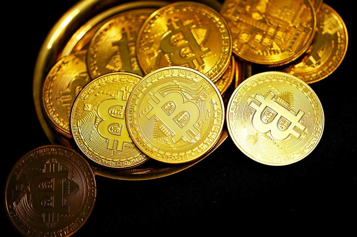 Bitcoins toppled over on a gold plate