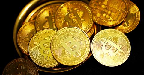 Bitcoins toppled over on a gold plate