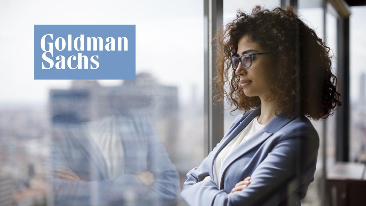 Woman looking out a window and Goldman Sachs logo