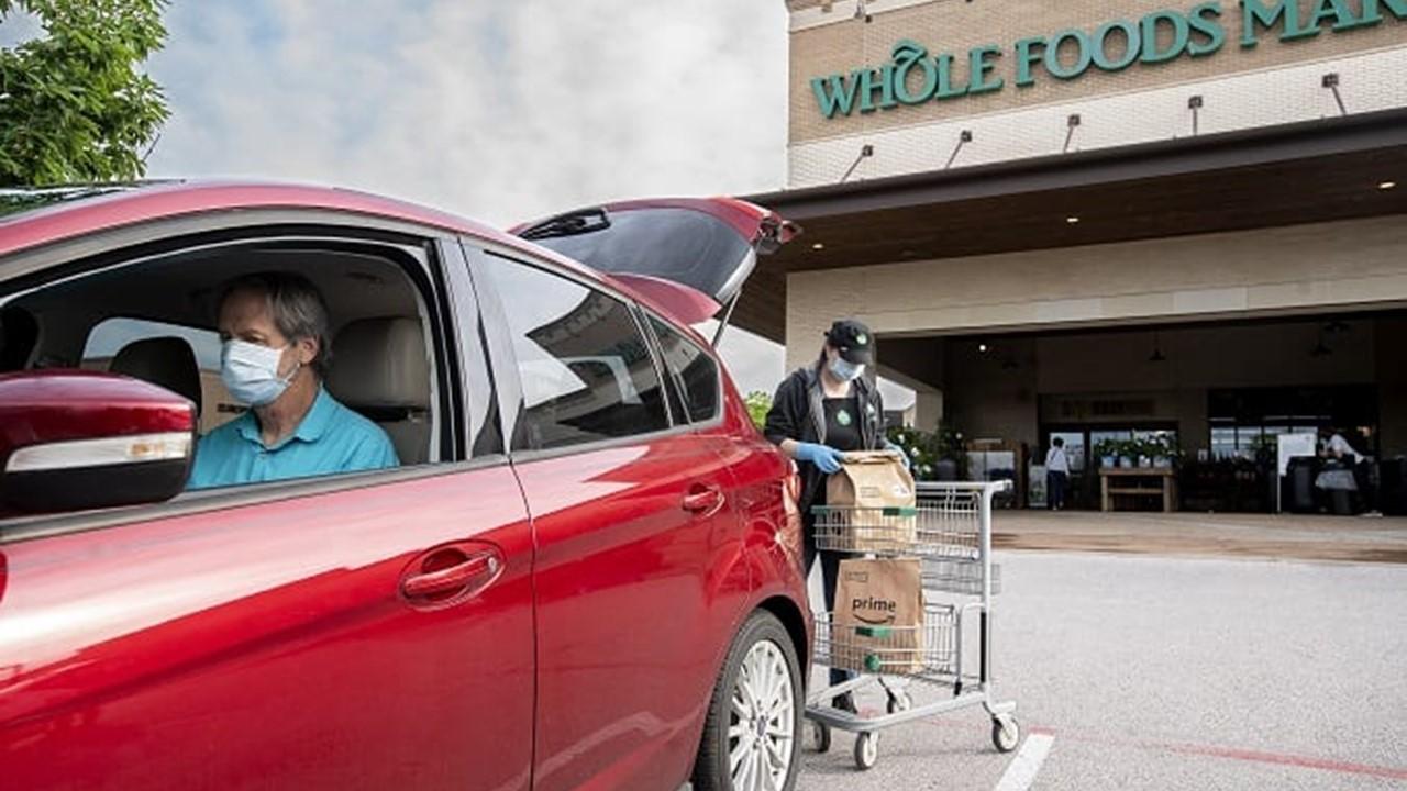 A man getting his Amazon order from Whole Foods