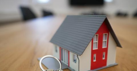Miniature house and keys on a table
