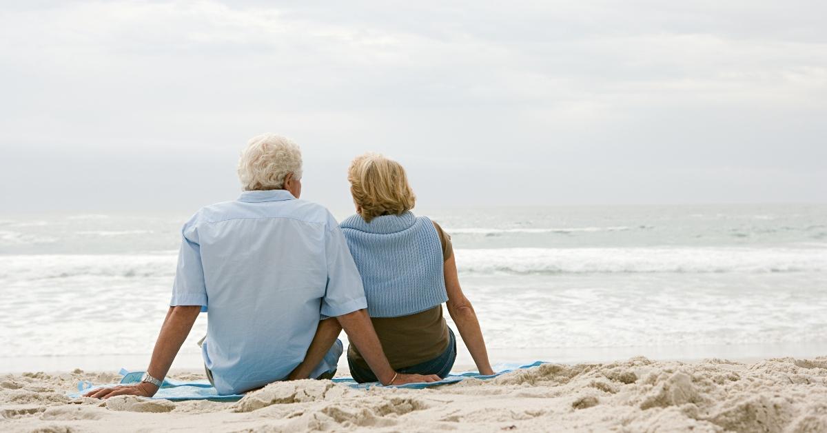 Elderly couple sitting on the beach