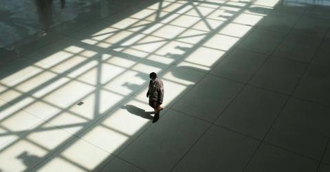 Worker walking through empty airport terminal