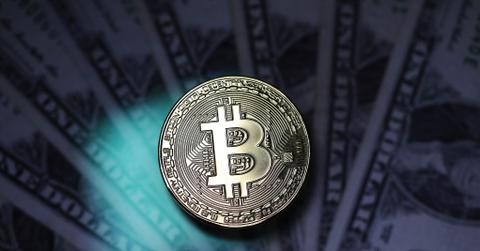 Bitcoin and dollar bills