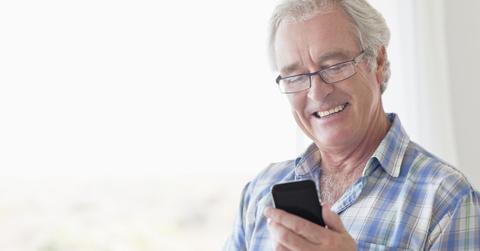 A man blocking spam texts on his iPhone