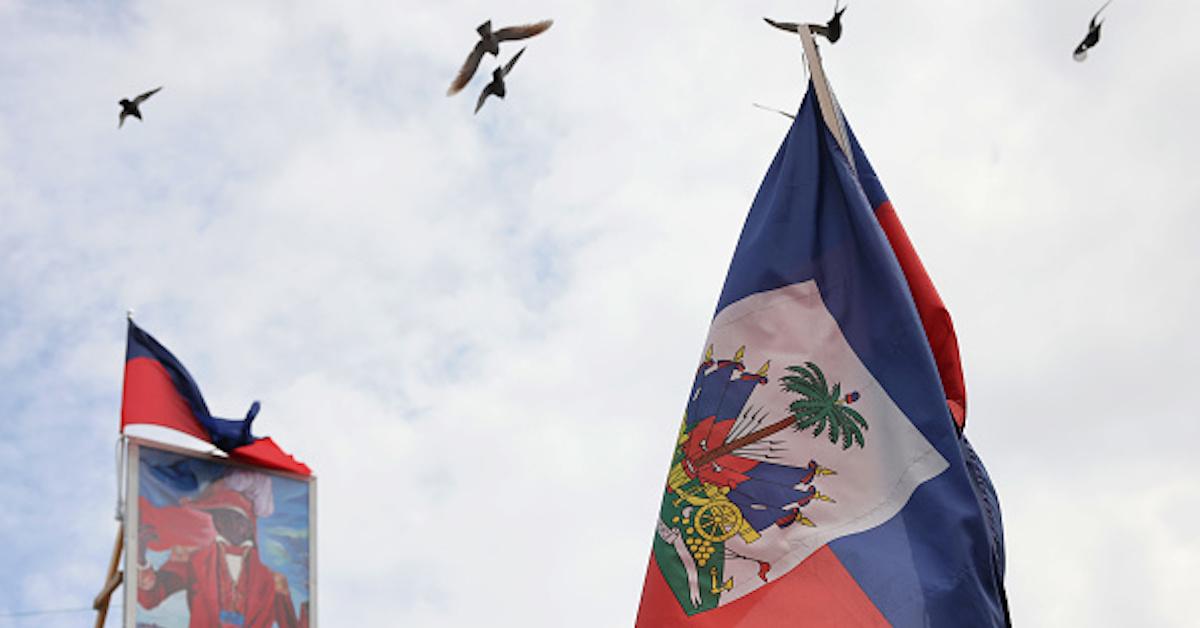 Toussaint Louverture painting and Haitian flag