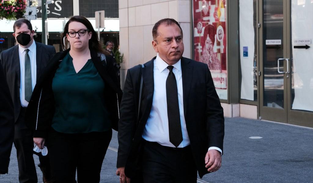 Ramesh Sunny Balwani walking outside of courthouse during trial