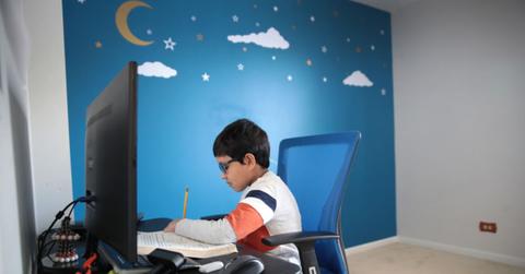 Child doing school work on a computer at home