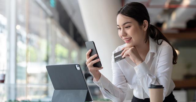 A woman adding a credit card to Apple Pay.