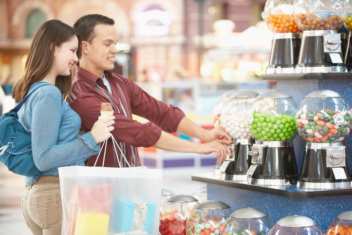 Man and woman at a candy vending machine