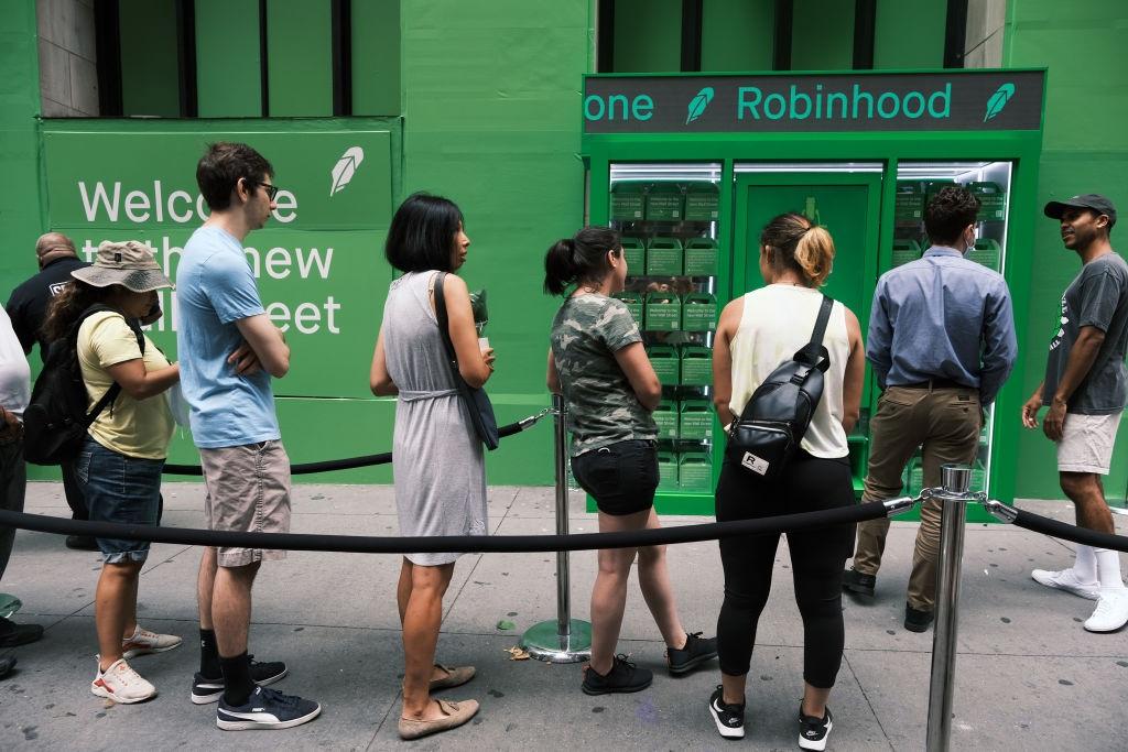 People waiting in line by a Robinhood sign