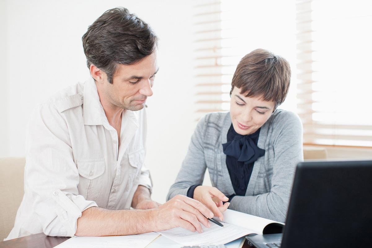 Two people looking over mortgage paperwork