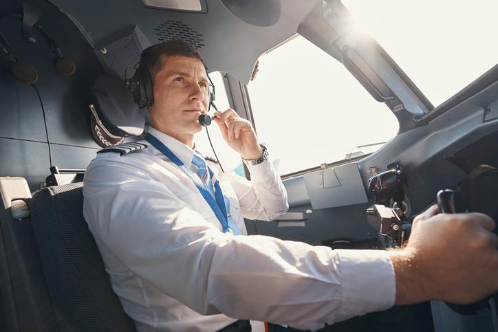 A pilot is seen in-flight in an airplane