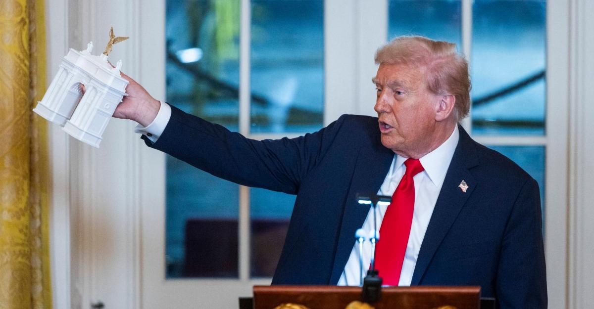 Trump holds model of the Arc de Trump