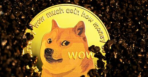 The meme coin "Doge" on black stones.