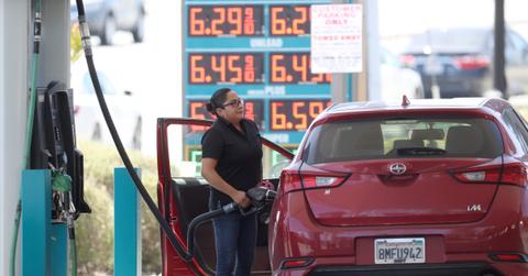 A woman putting gas in her car
