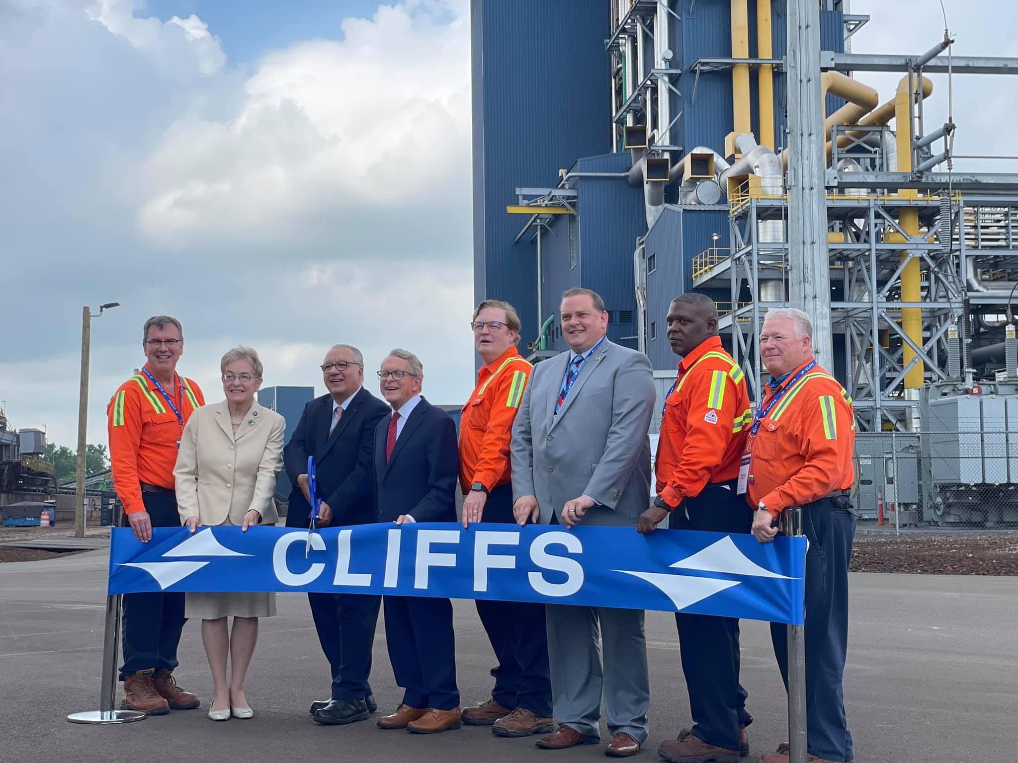 Cleveland-Cliffs employees holding a company banner