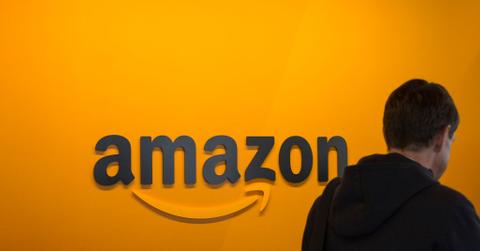 A man walking past an Amazon sign