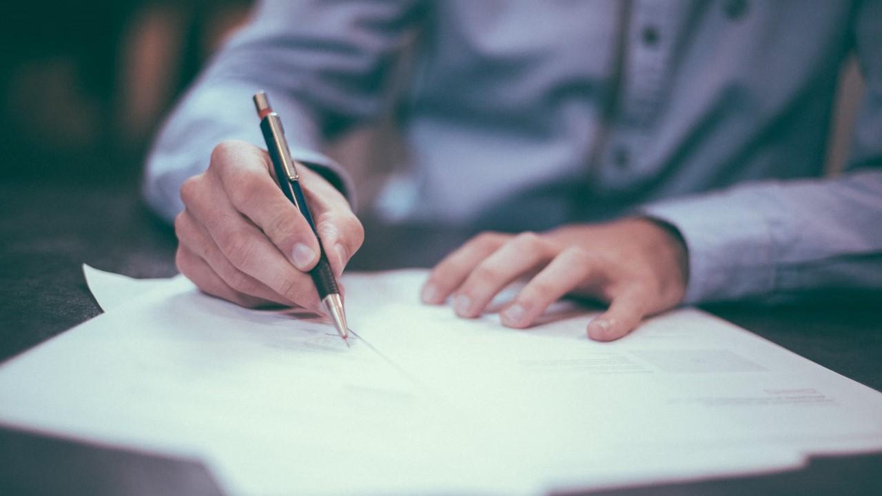 Man signing cash-out refinance paperwork