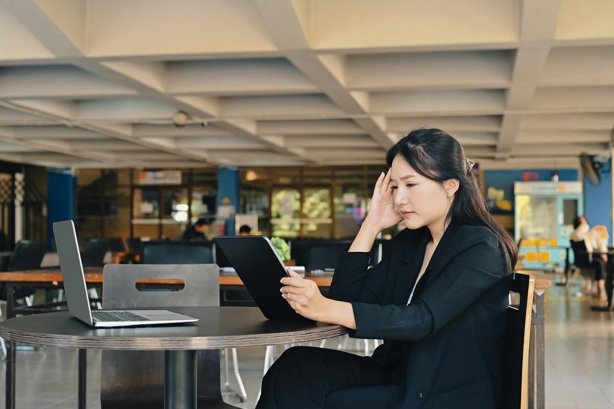 Stressed businesswoman sitting in office 