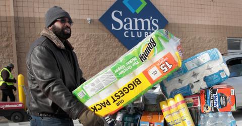 A man pushing a cart outside of Sam's Club