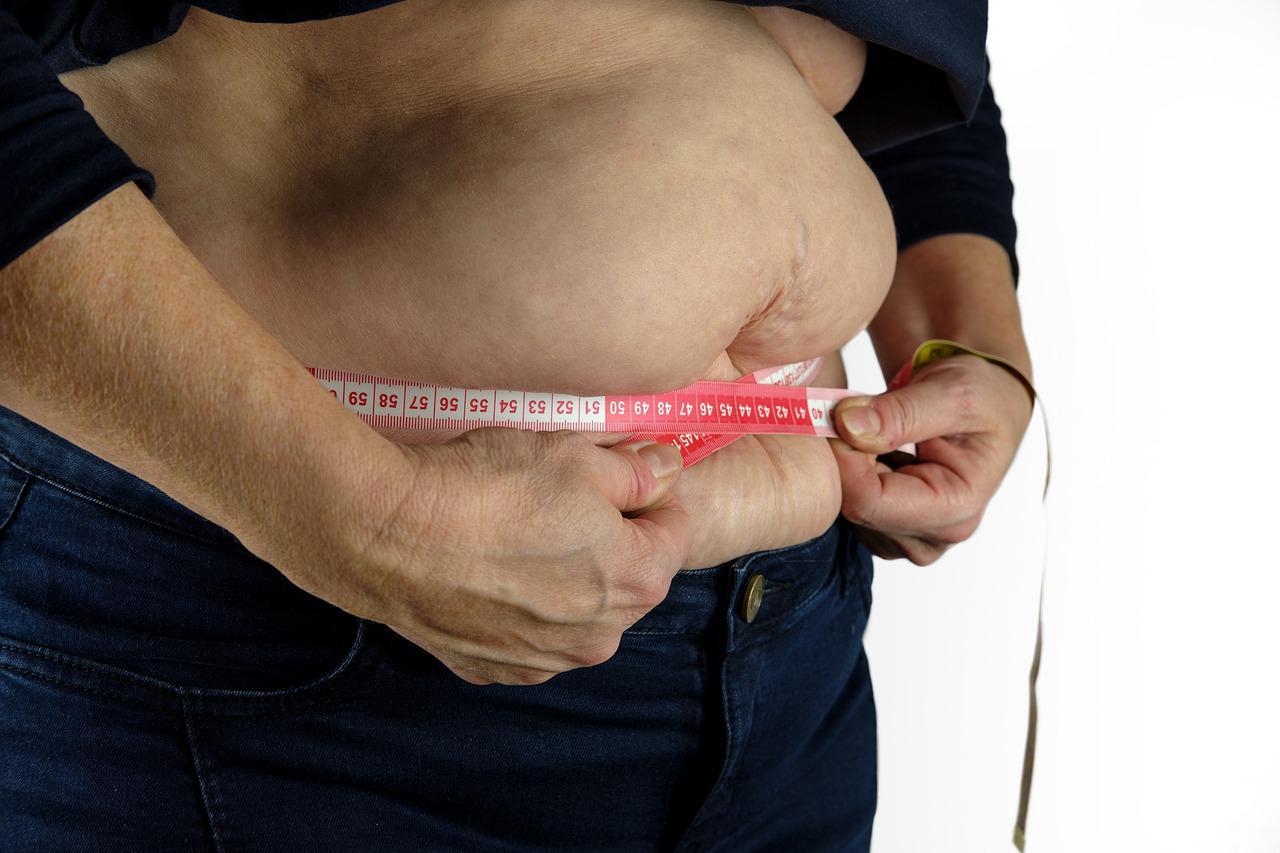 A person measuring their belly