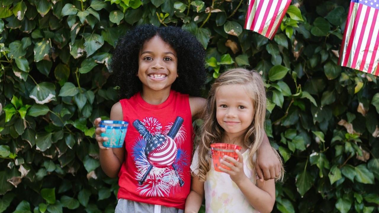 Two children holding drinks