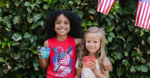Two children holding drinks