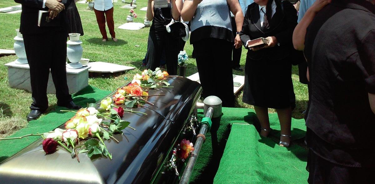 A casket with flowers at a cemetery