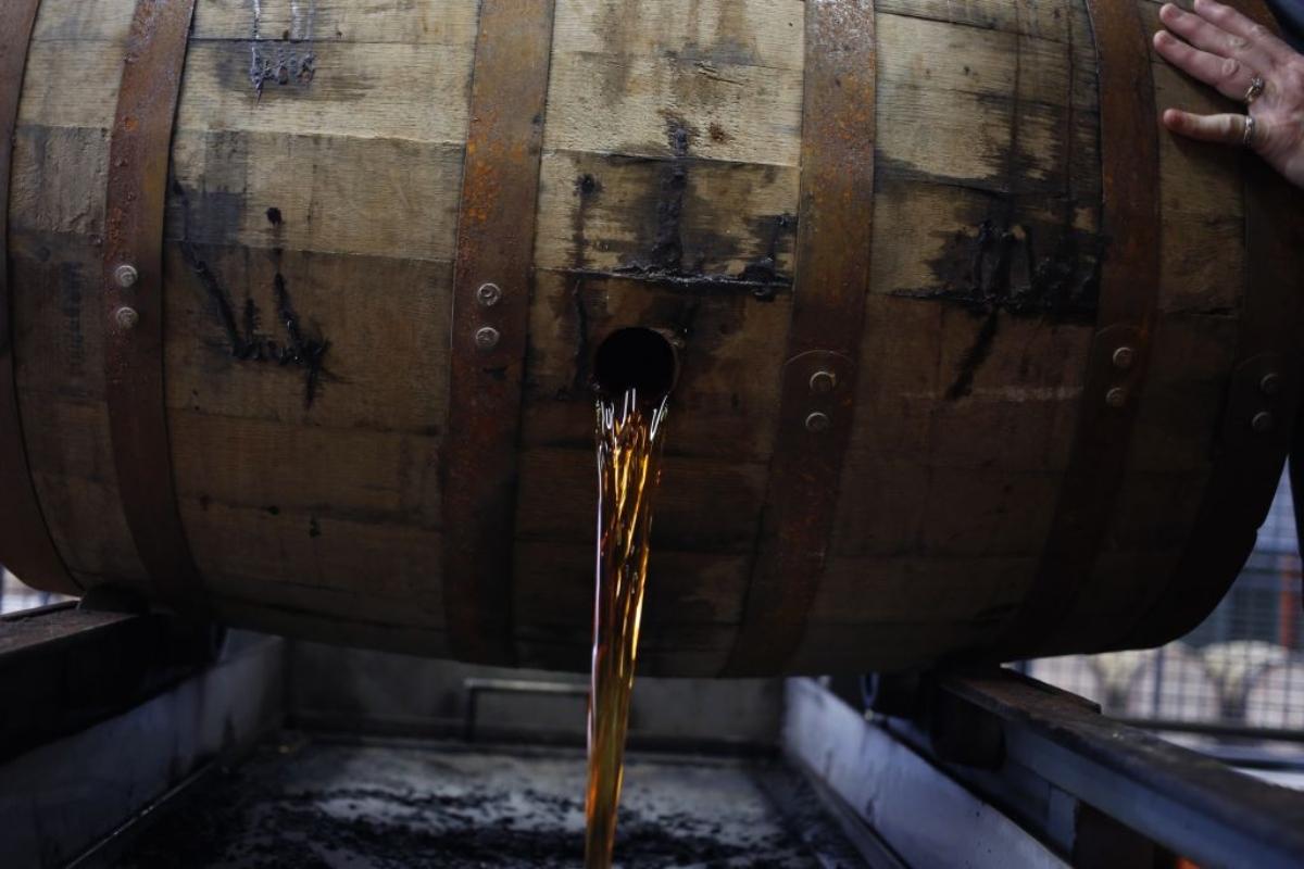 Bourbon pouring from a barrel