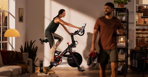 Woman using a Peloton bike