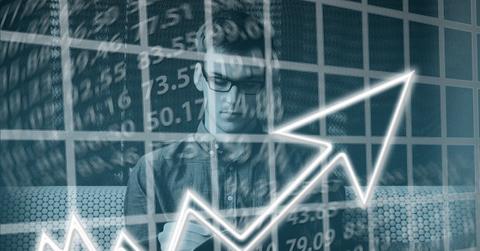 A graph of inflation rates with a person working in the background