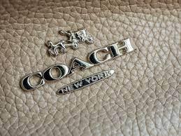 A Coach New York logo on a handbag