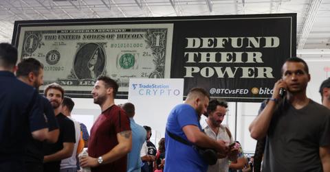 People standing in front of a DeFi banner