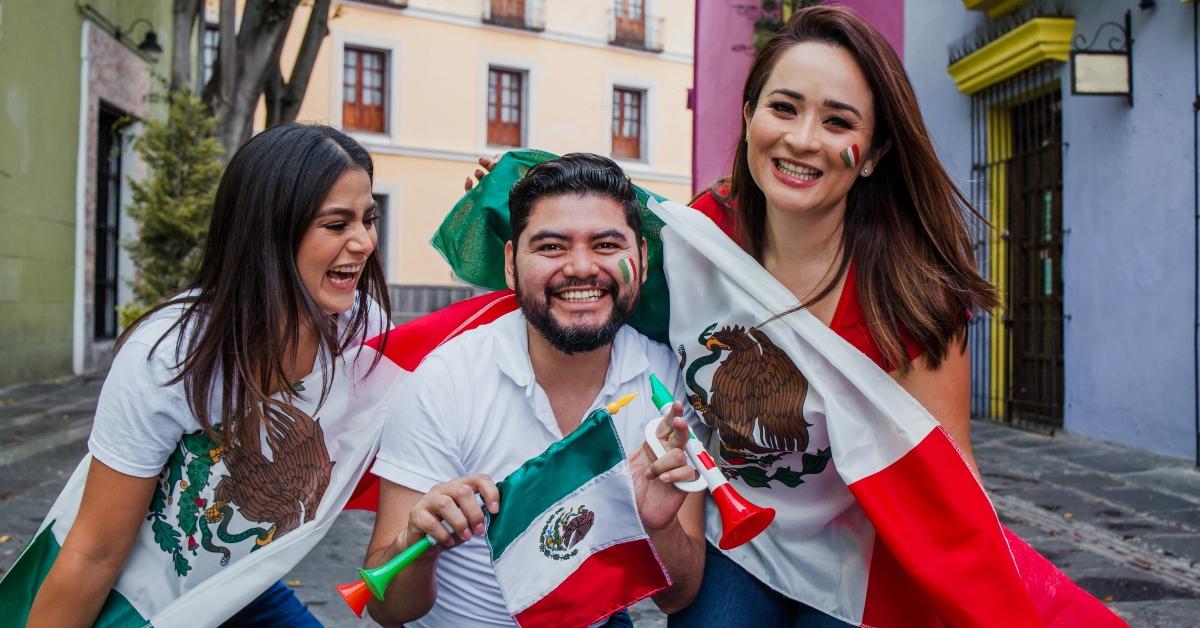 People celebrating Cinco de Mayo with Mexican flags