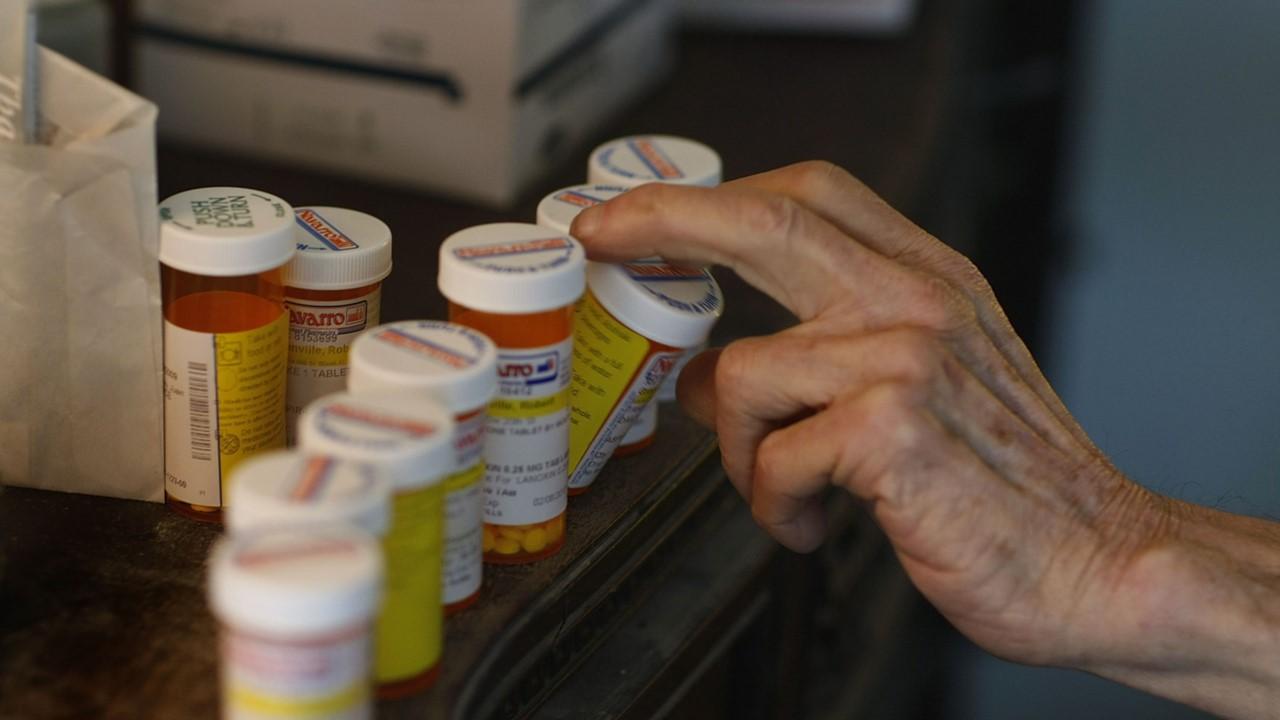 A man reaching for his prescription drugs