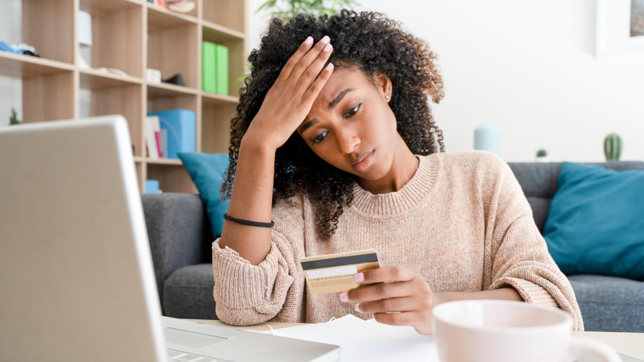 A woman looking at her credit card debt