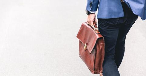 A person leaving their job with briefcase