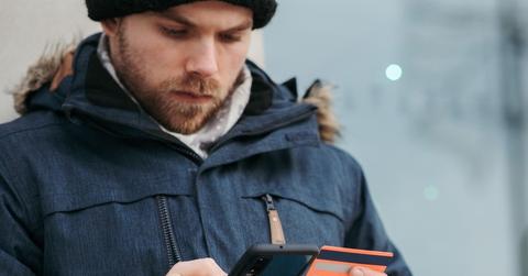 Pensive man holding credit card