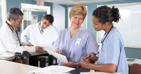Group of doctors and nurses having a discussion in a hospital