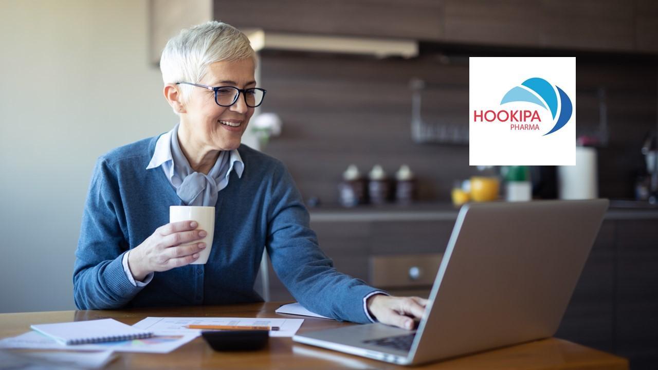 Woman looking on a laptop and Hookipa Pharma logo