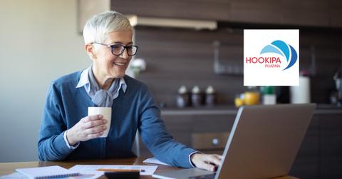 Woman looking on a laptop and Hookipa Pharma logo