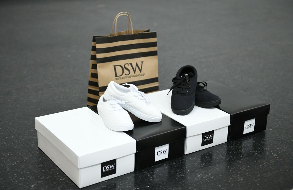 Boxes of black and white shoes with a DSW bag behind them