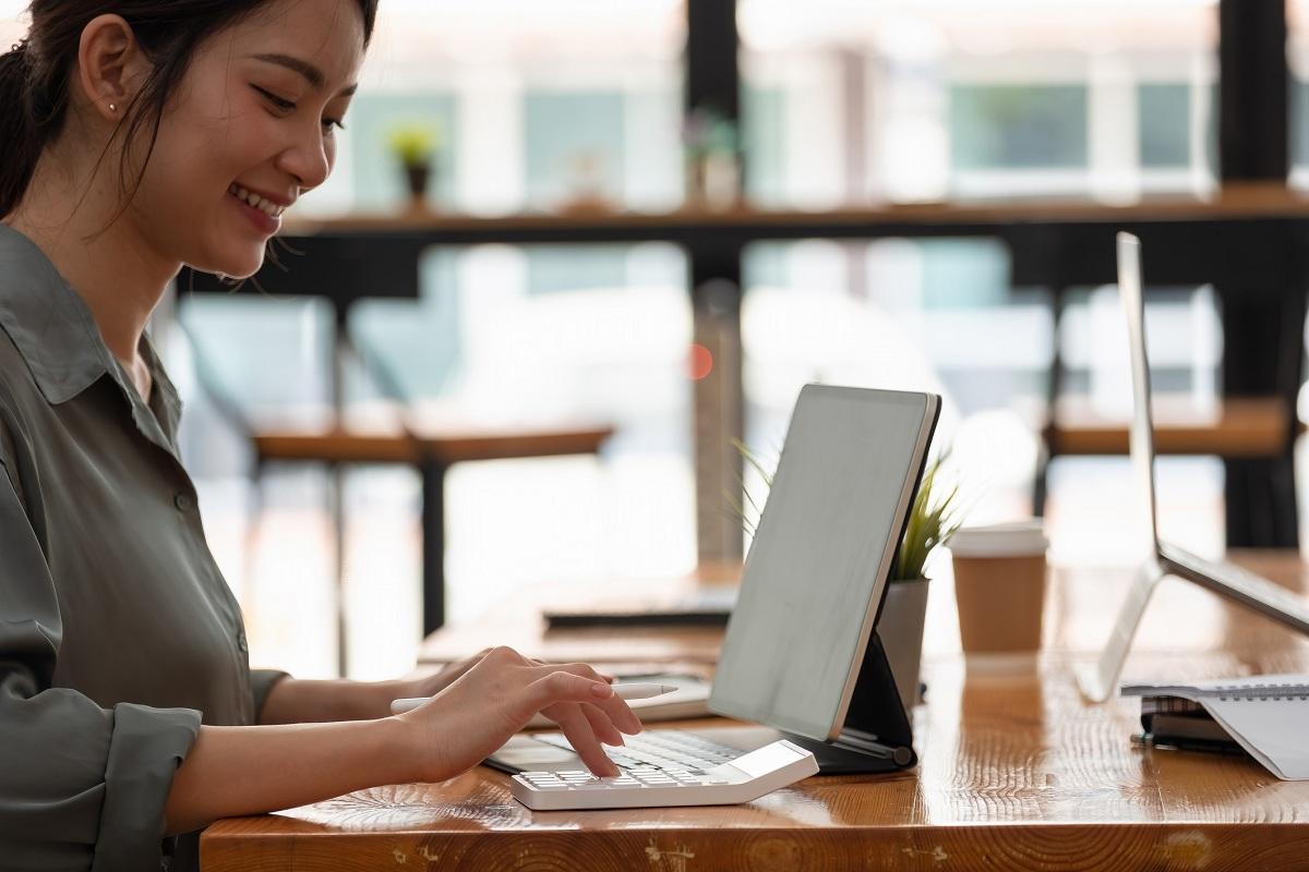 A person working on a laptop in a café