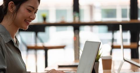 A person working on a laptop in a café
