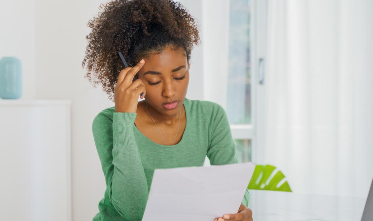 A woman looking a credit card debt paperwork