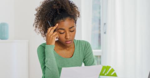 A woman looking a credit card debt paperwork