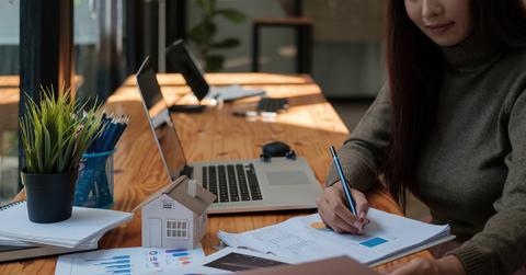 A person calculating real estate costs