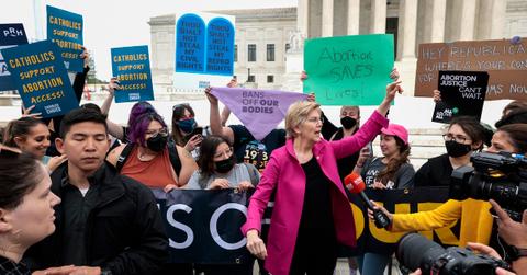 Sen. Elizabeth Warren (D-MA) stands with pro-choice activists protesting outside the Supreme Court after a rumored draft opinion that would overturn Roe v. Wade was leaked to POLITICO.